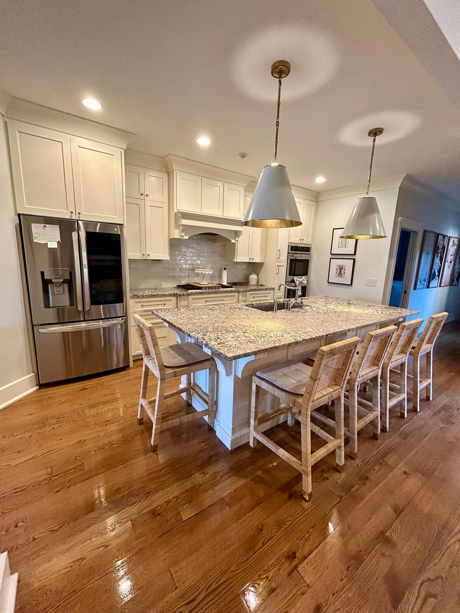 A bright, immaculately cleaned kitchen with a large stone island
